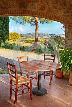 Beautiful view with table and chairs at a open terrace in italian village, Italy.
