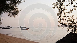 Beautiful view to the tropical beach at the sunset time.