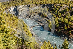 Beautiful view from top of mountains at river valley with wooden hunchbacked bridge