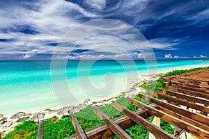 Beautiful view from the top of the roof on tropical white sand beach and tranquil turquoise tender ocean on sunny summer day