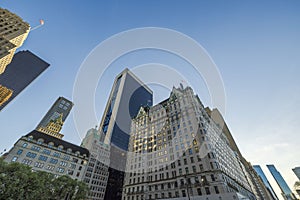 A beautiful view of the tops of New York skyscrapers against the backdrop of a cloudless blue sky.