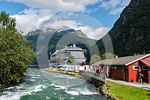 Beautiful view of the tourist ferry on Fjord Sea near the port in Geiranger village, Norway