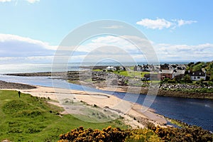 A beautiful view of the town of Brora, with homes along the coast on a sunny spring day in Scotland