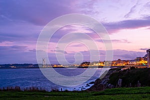 Beautiful view of a town at a seascape at purple sunset
