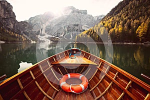 Traditional rowing boat on a lake in the Alps in fall