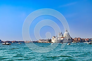 Beautiful view of traffic on famous Canal Grande with Basilica di Santa Maria della Salute, Venice, Italy