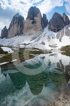 Beautiful view of Tre Cime di Lavaredo reflecting in the water. Dolomites, Italy