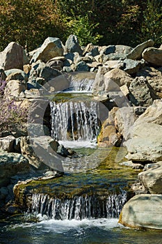 Beautiful view of Triple waterfall in Japanese garden. Public landscape park of Krasnodar or Galitsky Park, Russia