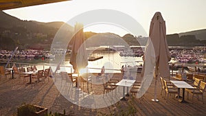 Beautiful view of tropical beach with chairs, umbrellas and moored yachts