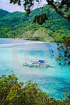 Beautiful view of a tropical island Snake with white traditional banca boat full tourists. El Nido, Palawan, Philippines photo