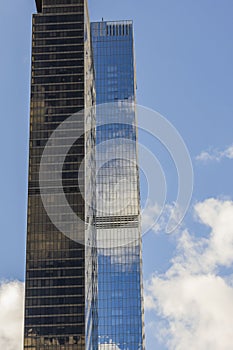 Beautiful view of two skyscrapers on blue sky and white clouds background. New York.