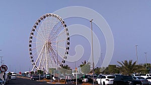 Beautiful view of the UAE flag waving in front of the Marina eye wheel