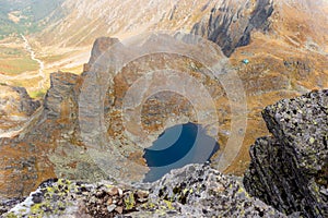 Beautiful view of a valley with a lake in Fagaras Mountains on a sunny autumn day