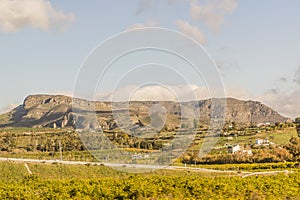 Beautiful view of a valley with small houses, trees and a road with a mountain in the background