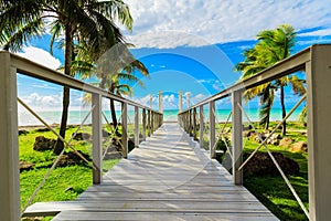 Beautiful view on walkway, bridge leading to the tranquil inviting ocean and beach on sunny nice day