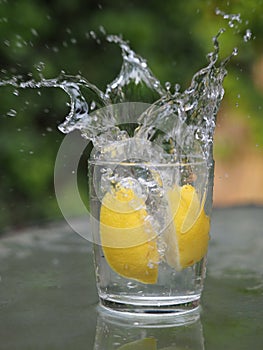 Beautiful view of water drops over a glass of lemons