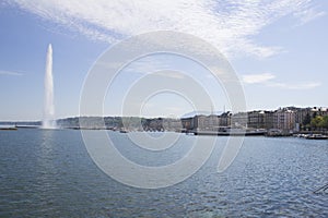 Beautiful view of the water jet fountain in the lake of Geneva, Switzerland. Geneva cityscape with its famous Jet d`Eau