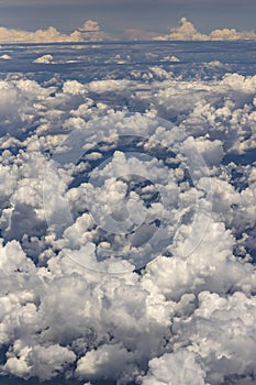 Beautiful view from window of plane flying over clouds. Natural panorama with clouds.