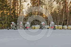 Beautiful view of winter landscape with view of snow cannons to make artificial ski tracks.
