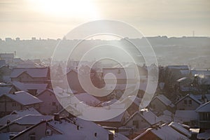 Beautiful view of winter morning fog, snow and sun filling on landscape of houses and buildings in Belgrade.