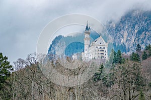 Beautiful view of world-famous Neuschwanstein Castle built for King Ludwig in fog near Fussen, southwest Bavaria, Germany