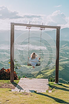 Beautiful view of young woman swing on the top of the mountain Redonda in Dominican Republic. Concept travel, vacation