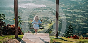 Beautiful view of young woman swing on the top of the mountain Redonda in Dominican Republic. Concept travel, vacation