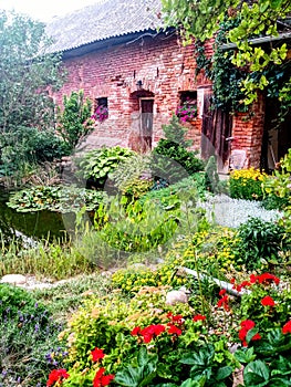 Beautiful village Garden with brick stables, pond and flowers