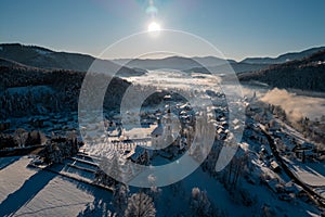 Beautiful village of Ljubno ob Savinji, home of female ski jump competition. Winter panorama from above the village in early photo