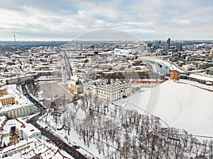 Beautiful Vilnius city panorama in winter with snow covered houses, churches and streets. Aerial view. Winter city scenery in