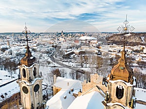 Beautiful Vilnius city panorama in winter with snow covered houses, churches and streets. Aerial view. Winter city scenery in