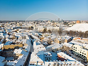 Beautiful Vilnius city panorama in winter with snow covered houses, churches and streets. Aerial view. Winter city scenery in