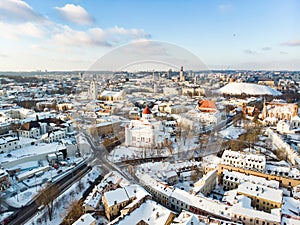 Beautiful Vilnius city panorama in winter with snow covered houses, churches and streets. Aerial view. Winter city scenery in