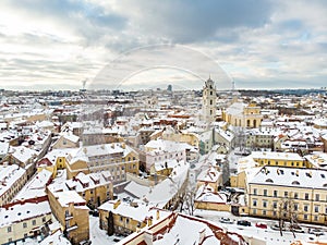 Beautiful Vilnius city panorama in winter with snow covered houses, churches and streets. Aerial view. Winter city scenery in