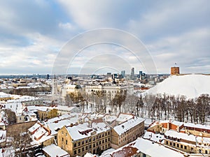 Beautiful Vilnius city panorama in winter with snow covered houses, churches and streets. Aerial view. Winter city scenery in