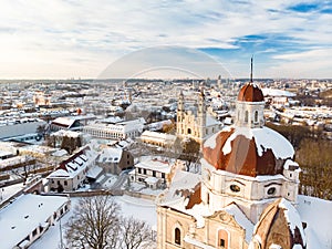 Beautiful Vilnius city panorama in winter with snow covered houses, churches and streets. Aerial view. Winter city scenery in