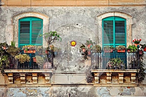 Beautiful vintage balcony with colorful flowers and doors