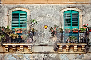 Beautiful vintage balcony with colorful flowers and doors photo