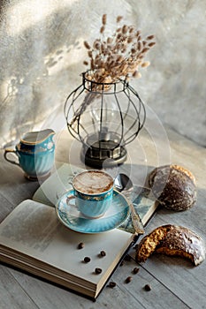 Beautiful vintage cup of coffee with milk and gingerbread on the table