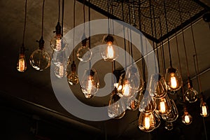 Beautiful vintage luxury light bulb hanging decor glowing in dark.