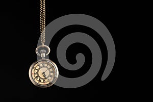 Beautiful vintage pocket watch with chain on black background, space for text. Hypnosis session