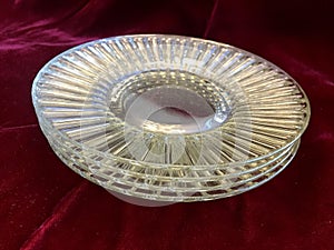 Beautiful Vintage Shiny Crystal Glass Dessert Plates on Red Velvet Background