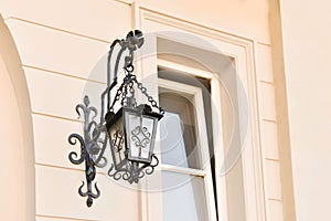 Beautiful vintage street lamp hanging on wall of building