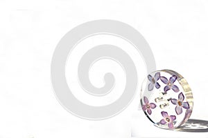 Beautiful violet button isolated on white background situated bottom right.