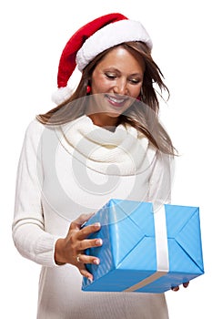 Beautiful vivacious woman with a Christmas gift