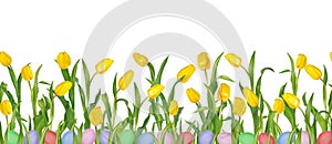 Beautiful vivid yellow tulips on long stems with green leaves and colorful Easter eggs in seamless pattern.