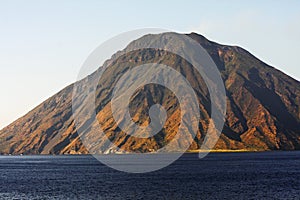 Beautiful volcanic island with green vegetation in the Mediterranean Sea on a clear sunny day