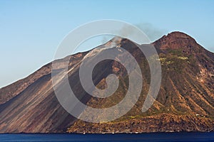 Beautiful volcanic island with green vegetation in the Mediterranean Sea on a clear sunny day