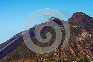 Beautiful volcanic island with green vegetation in the Mediterranean Sea on a clear sunny day