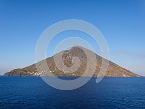 Beautiful volcanic island with green vegetation in the Mediterranean Sea on a clear sunny day